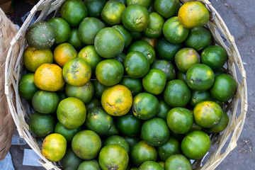 Fresh mandarin oranges on an organic food market of tropical Bali island, Indonesia. Mandarin background.