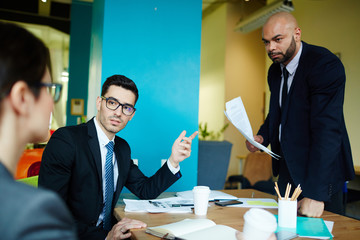Serious reporters discussing information for news report