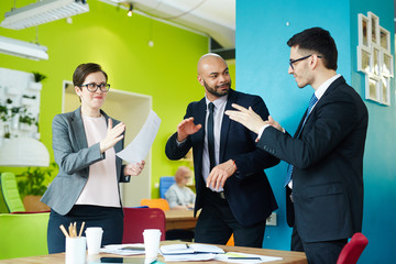 Energetic co-workers dancing in studio at break