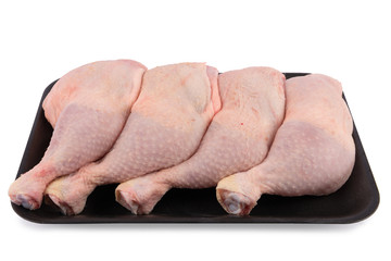 Raw chicken thighs isolated on white background.