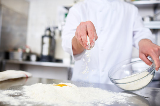 Chef working with flour and raw eggs