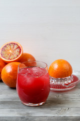 Red orange juice. Grey wooden background. Top view.