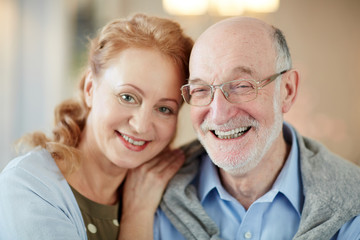Affectionate husband and wife looking at camera