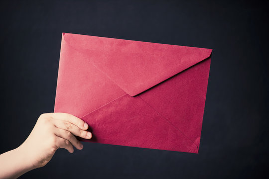 Hand holds an envelope