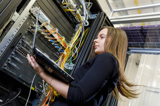 Young woman engineer at the network equipment