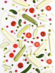 Fresh vegetables in a cut on a white background. Pattern from vegetables. Food background.  Cucumbers, tomatoes and zucchini in a cut.