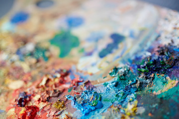 Fototapeta premium Closeup macro shot of colorful oil paint mix on artists palette, selective focus