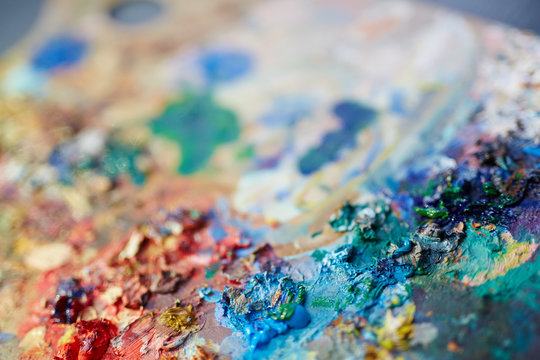 Closeup macro shot of  colorful oil paint mix on artists palette, selective focus