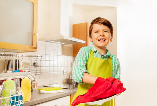 Happy Kid Boy Wiping Dry Plate With Red Dish Towel