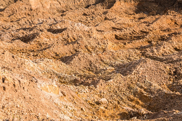 Clay and sand in the quarry. Beautiful unusual background similar to the surface of the planet Mars or the moon