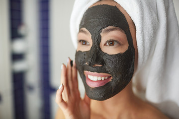 Closeup portrait of beautiful Asian woman applying face mask