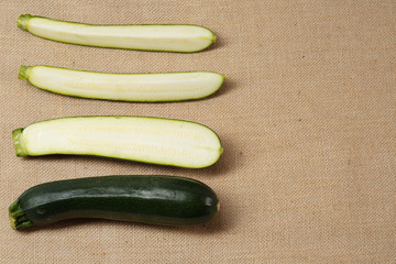 Fresh Zucchini lying on a sackcloth surface