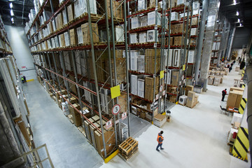 Large factory or warehouse with goods and workers