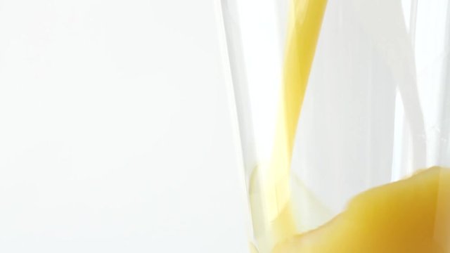Freshly squeezed orange juice in a glass. White background. Healthy eating.