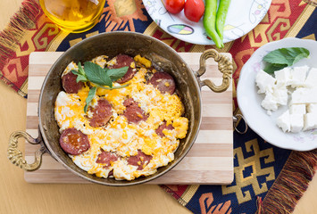 Fried eggs with pepperoni with fresh tomato and peppers and cheese