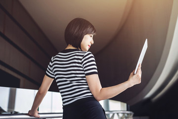 Asian working woman read data in digital tablet