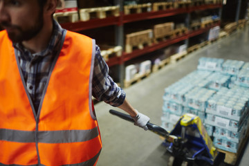 Packed goods on forklift being pulled by worker © pressmaster