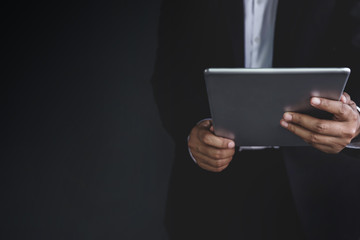 Part of Businessman using digital tablet, Dark tone