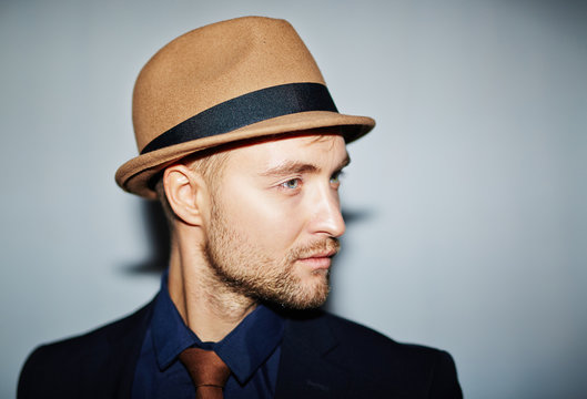 Attractive young man in hat and suit