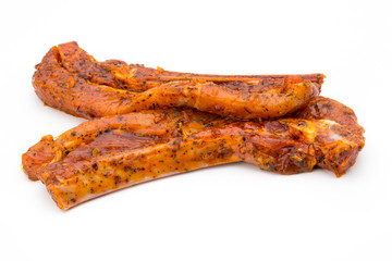 Spicy marinated spare ribs barbecued on the white background.