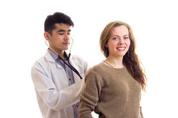 Doctor listening to woman's back