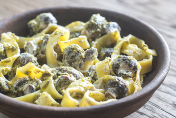 Portion of creamy mushroom pasta with pesto
