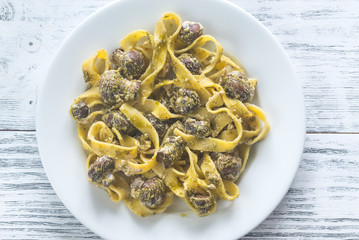 Portion of creamy mushroom pasta with pesto