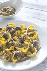 Portion of creamy mushroom pasta with pesto