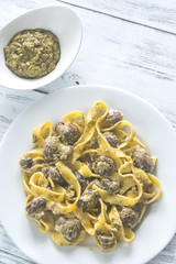 Portion of creamy mushroom pasta with pesto