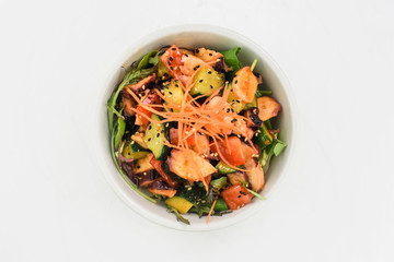 Seafood salad with cucumbers, pulp, carrots and balsamic vinegar