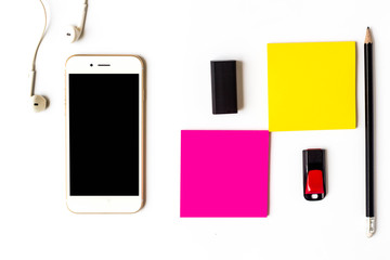 Top view of items smartphone and sticky notes.