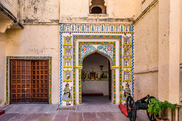 Colorful gate at Udaipur castle courtyard, India.