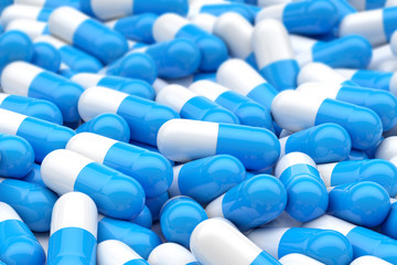 white and blue capsule pills on background, 3D rendering