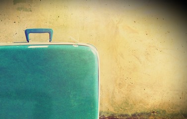 Vintage suitcase with copy space wall background 