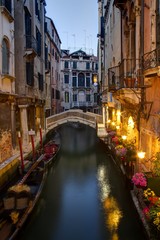 Obraz na płótnie Canvas Evening on a Venice Canal with docked Gondolas