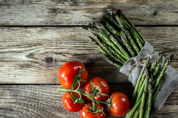 Brunch of Fresh Asparagus on vintage wooden background. place for text