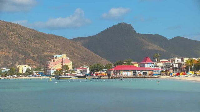Philipsburg St. Maarten Boardwalk on Great Bay Beach in a Vibrant Exotic Setting with Mountains in the Background on a Sunny Day in the Caribbean