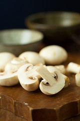 Champignon mushrooms on the wooden table. Selective focus
