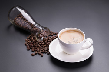 Hot americano coffee in white glass on black background
