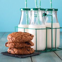 A bottles of milk on a wooden table on a blue background healthy food