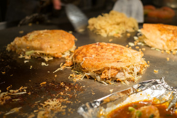 Japanese pizza cooking on the iron plate