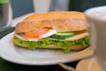 Fresh Sandwich with Ham, Cheese, and Vegetables on Ciabatta Bread