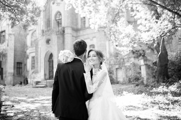 Wedding couple walking near beautiful view to the old couple