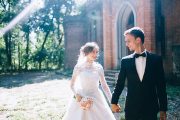 Married couple walking near the old beautiful castle