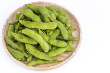 Green soybean (Vegetable soybean) boiled in wooden plate on white