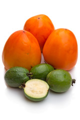 Persimmon and feijoa on white