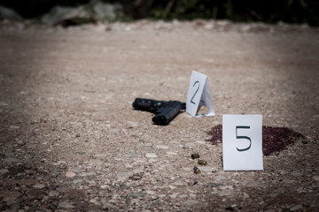The crime scene, murder, investigation, gun and shell finds the police, puts tags rip shells and...