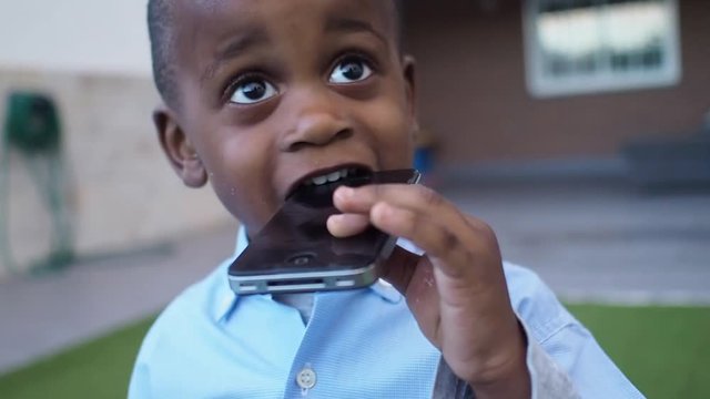 Young enough boy who breaks a smartphone