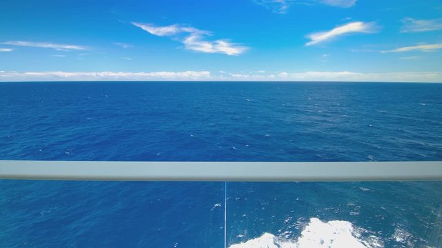 Cruise Ship Sailing on Tropical Blue Water Oceanscape Viewed from Onboard Private Stateroom Glass Balcony 