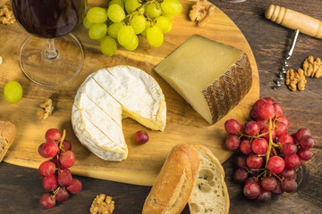 Cheese, bread and grapes at wine tasting